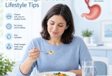 Person eating a small meal slowly at a table while managing achalasia with mindful eating habits.