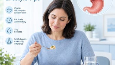 Person eating a small meal slowly at a table while managing achalasia with mindful eating habits.